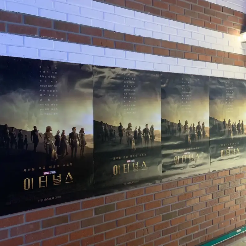 Posters of Eternals MCU movie on a brick wall