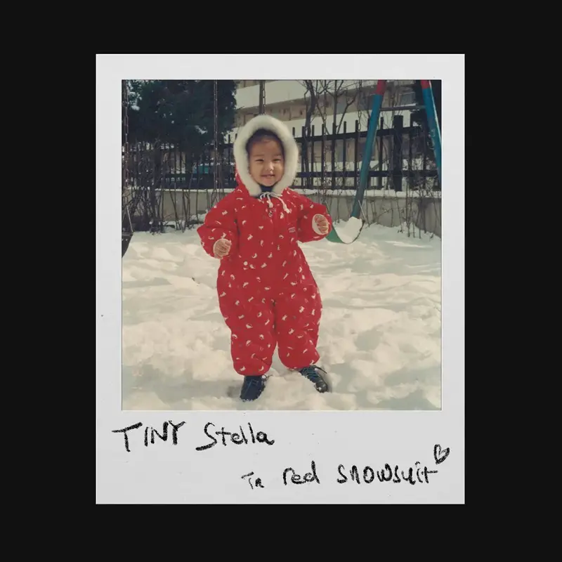 Tiny Stella in red snowsuit